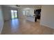Spacious living room with tile floors, black kitchen cabinets, and a view of the pond at 2355 Seven Oaks Dr, St Cloud, FL 34772