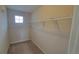 Spacious walk-in closet with ample shelving and carpeted floor for storage at 2355 Seven Oaks Dr, St Cloud, FL 34772