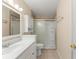 Bathroom featuring white vanity, tile floors, a mirrored medicine cabinet, and tiled shower at 2538 Meadowview Ln, Deland, FL 32720