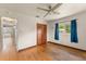 This bedroom features hardwood floors, a ceiling fan, and a window looking out to the yard at 2538 Meadowview Ln, Deland, FL 32720