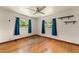 This bedroom features natural light from the windows and original hardwood floors at 2538 Meadowview Ln, Deland, FL 32720