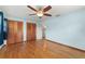 Bedroom with hardwood floors, ceiling fan, closet and bathroom access at 2538 Meadowview Ln, Deland, FL 32720