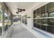 View of the home's screened-in porch featuring an overhead fan and large windows at 2538 Meadowview Ln, Deland, FL 32720