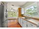 Kitchen with stainless steel refrigerator, white cabinets, wood cabinets, and view to the living room at 2538 Meadowview Ln, Deland, FL 32720