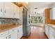 Renovated kitchen featuring stainless steel refrigerator, white cabinets, wood cabinets, and view to the living room at 2538 Meadowview Ln, Deland, FL 32720