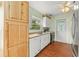 Cozy kitchen featuring wood cabinets, white appliances and door leading to back yard at 2538 Meadowview Ln, Deland, FL 32720