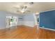 Bright living room with hardwood floors, ceiling fan, and sliding glass doors leading to the backyard at 2538 Meadowview Ln, Deland, FL 32720