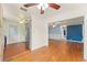 Open concept living room with hardwood floors, ceiling fan, and an open floorplan with blue accent wall at 2538 Meadowview Ln, Deland, FL 32720