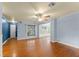 Living room with hardwood floors, a ceiling fan, and a large window, perfect for entertaining at 2538 Meadowview Ln, Deland, FL 32720