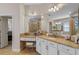 Primary bathroom with double sinks, granite countertop vanity and makeup table, walk-in shower, and soaking tub at 25554 Hawks Run Ln, Sorrento, FL 32776