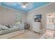Bedroom featuring a charming cloud ceiling, cozy daybed, unique hanging chair, and a connected bathroom at 25554 Hawks Run Ln, Sorrento, FL 32776