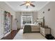 Bright bedroom featuring a queen bed, natural light, and whimsical decor creating a cozy and personalized space at 25554 Hawks Run Ln, Sorrento, FL 32776