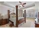 Spacious bedroom featuring a four poster bed, ceiling fan, and a sitting area with bay window at 25554 Hawks Run Ln, Sorrento, FL 32776