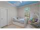 Inviting bedroom with a playful cloud ceiling, a comfortable daybed, and a whimsical hanging chair at 25554 Hawks Run Ln, Sorrento, FL 32776