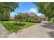 A paved driveway leads to a lovely home with lush landscaping and mature trees at 25554 Hawks Run Ln, Sorrento, FL 32776