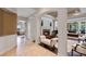 Hallway view to a fireplace with marble surround, columns, and dark hardwood floors at 25554 Hawks Run Ln, Sorrento, FL 32776