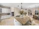 Open kitchen features a large island, granite countertops, stainless steel appliances and ample white cabinetry at 25554 Hawks Run Ln, Sorrento, FL 32776