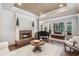 Spacious living room featuring a fireplace, piano, and bright natural light at 25554 Hawks Run Ln, Sorrento, FL 32776