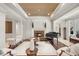 Bright and airy living room featuring a fireplace and piano at 25554 Hawks Run Ln, Sorrento, FL 32776