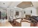 Elegant open-concept living room with a fireplace, piano, and decorative columns at 25554 Hawks Run Ln, Sorrento, FL 32776