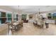 Open floor plan with a spacious dining area, kitchen island, and cozy living room at 25554 Hawks Run Ln, Sorrento, FL 32776