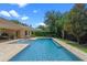 Landscaped backyard with sparkling pool and patio area for relaxing at 25554 Hawks Run Ln, Sorrento, FL 32776