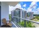 Relaxing balcony view overlooking a luxurious building, with a comfortable chair for enjoying the scenery at 260 S Osceola Ave # 902, Orlando, FL 32801