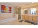 Luxurious bathroom featuring a soaking tub, glass-enclosed shower, and double vanity at 260 S Osceola Ave # 902, Orlando, FL 32801