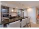 Modern kitchen with a countertop bar, pendant lights, and stainless steel appliances at 260 S Osceola Ave # 902, Orlando, FL 32801