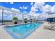 Stunning rooftop pool surrounded by lounge chairs and palm trees, offering a luxurious oasis at 260 S Osceola Ave # 902, Orlando, FL 32801