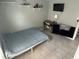 Bedroom featuring tiled floors, shelves, a desk, a ceiling fan, and a TV at 2833 Woodruff Dr, Orlando, FL 32837