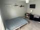 Bedroom with shelves, desk, and TV, offering a functional and cozy space at 2833 Woodruff Dr, Orlando, FL 32837