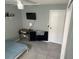 Bedroom featuring tiled floors, shelves, a desk, a ceiling fan, and a TV at 2833 Woodruff Dr, Orlando, FL 32837
