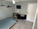 Cozy bedroom featuring desk, TV, and ample natural light at 2833 Woodruff Dr, Orlando, FL 32837