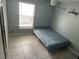 Bedroom with tiled floors, a ceiling fan, a window with blinds, and shelves at 2833 Woodruff Dr, Orlando, FL 32837