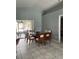 Inviting dining room with a glass table, modern chairs, and access to a patio at 2833 Woodruff Dr, Orlando, FL 32837