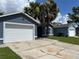 Lovely single-story home showcasing a well-kept lawn, driveway, and pleasant blue exterior at 2833 Woodruff Dr, Orlando, FL 32837