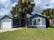 Attractive single-story home featuring a manicured lawn and a charming blue exterior at 2833 Woodruff Dr, Orlando, FL 32837