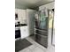 Well-equipped kitchen with stainless steel appliances, white cabinets, and tiled flooring at 2833 Woodruff Dr, Orlando, FL 32837