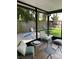 Enclosed patio features seating, pillows and overlooks the backyard at 2833 Woodruff Dr, Orlando, FL 32837