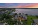 Stunning lakefront home with lush landscaping, private dock, and panoramic sunset views at 2937 Butler Bay N Dr, Windermere, FL 34786