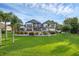 Beautiful backyard featuring a lush lawn, landscaped garden, and expansive patio at 2937 Butler Bay N Dr, Windermere, FL 34786