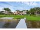 Expansive backyard with manicured lawn, waterfront access and private dock at 2937 Butler Bay N Dr, Windermere, FL 34786
