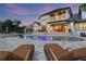 Relaxing backyard with an inground pool, patio dining, and lounge chairs under a colorful sky at 2937 Butler Bay N Dr, Windermere, FL 34786