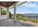 Balcony with stone floors and arched railings, offering views of the lake, lawn, and boat docks at 2937 Butler Bay N Dr, Windermere, FL 34786