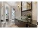 Hall bathroom offers a custom glass sink, mosaic tile accents, and stunning water view at 2937 Butler Bay N Dr, Windermere, FL 34786