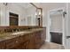 Bathroom featuring granite countertops, wood cabinets, and a large framed mirror at 2937 Butler Bay N Dr, Windermere, FL 34786