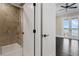 Bathroom showcases a glass door shower, a closet, and a view of the balcony and lake at 2937 Butler Bay N Dr, Windermere, FL 34786