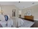 Comfortable bedroom with light walls, plush bedding, and dark hardwood floors at 2937 Butler Bay N Dr, Windermere, FL 34786