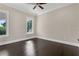 Bedroom features a ceiling fan, hardwood floors, neutral paint, and a window view at 2937 Butler Bay N Dr, Windermere, FL 34786